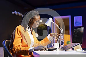 IT expert in home office working with code editor on laptop