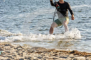 Expert Kitesurfer Planing close to the beach with Pictoresque Sea Watrer Splashes at sunset