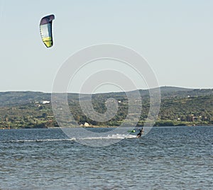 Expert Kitesurfer Planing with  Sea Watrer Splashes during Golden Hour