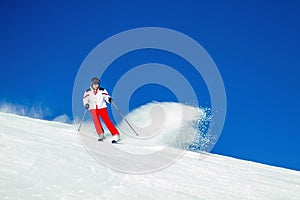 Expert Male Skier Carving Through Fresh Snow