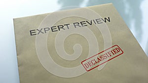 Expert review declassified, seal stamped on folder with important documents photo