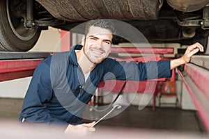 Expert With Wrench Repairing Car In Garage