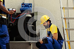 Experts fixing defective blower fan