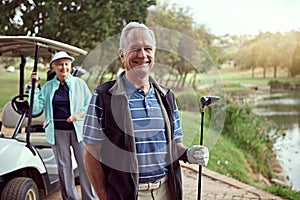 Experts in this game. Portrait of a smiling senior couple enjoying a day on the golf course.