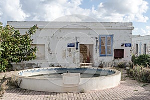 Expired ticket office in white peeled paint