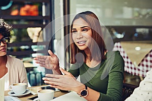 Explaining her point of view over the matter. Cropped shot of designers having a meeting at a coffee shop.