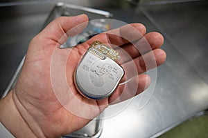 Explanted defibrilator is in one hand photo