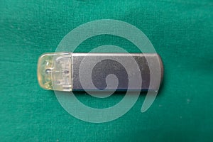 explanted event recorder on a green surgical drape