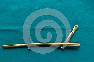 explanted titanium femur nail on a green surgical drape