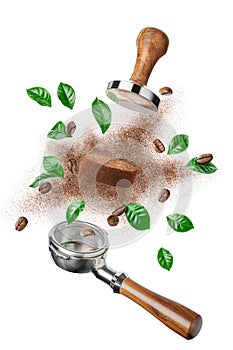 Exploded view of coffee holder and tamper with roasted beans and leaves photo