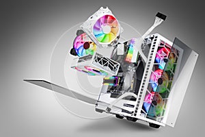 Exploded view of white gaming pc computer with glass windows and rainbow rgb LED lights. Flying hardware components abstract photo