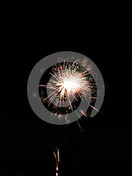 Exploding fireworks display centered in black sky
