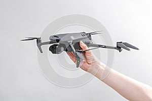 Explore consumer drone with unique tele camera scout and plan your shots in hand on gray background