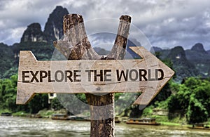 Explore the World wooden sign with a forest background photo