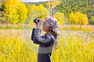 Explorer binocuar kid girl in yellow autumn nature