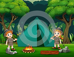 The explorer boy and girl camping in the forest