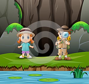 The explorer boy with a little girl at nature