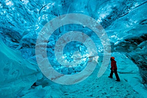 Explorer inside an ice cave, vatnajokull national park, Iceland