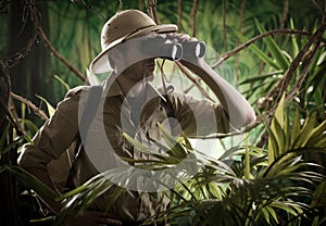 Explorer in the jungle with binoculars