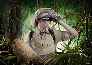 Explorer in the jungle with binoculars