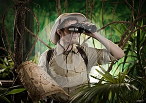 Explorer in the jungle with binoculars photo