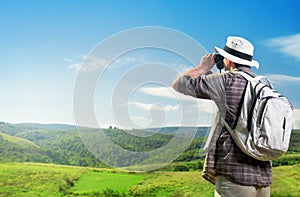 Explorer looking through binoculars outdoors