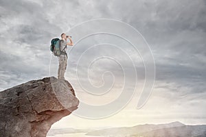 Explorer on the peak of a mountain