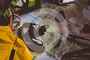 Exploring Adventure Hiking Concept. Looking navigation map in tent at night under light of small headlamp. Tourist traveler