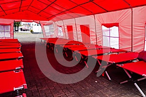 Natural disaster aid. Emergency beds arrangement in prepared tent photo