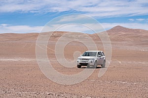 Exploring Atacama Desert vast dry extensions in the driest area of this amazing desert with an all terrain vehicle. An awe road