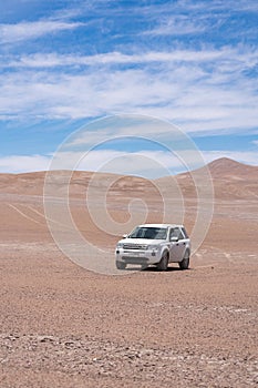 Exploring Atacama Desert vast dry extensions in the driest area of this amazing desert with an all terrain vehicle. An awe road