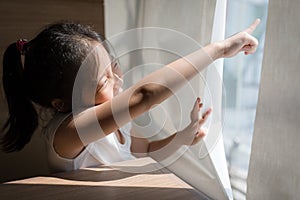 Exploring Concept Illustrated by Asian Child Looking and Pointing Out Window