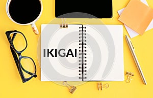 Exploring the Japanese Concept of Ikigai Through Notebook and Accessories on a Yellow Background photo