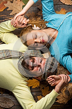 Exploring the world together. family play in autumn leaves. happy couple in love lying on fall background. fall couple