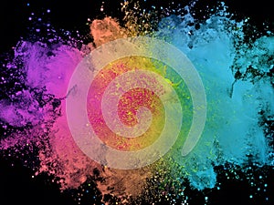 Explosion of colored powder on black background