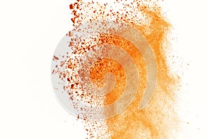 Explosion of colored powder on white background. Orange colored