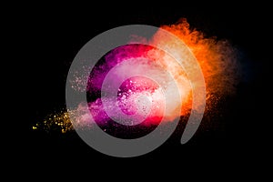 Explosion of colorful pigment powder on black background.Vibrant color dust particles textured background