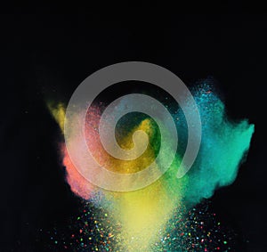 Explosion of colorful powder isolated on dark black background. Holi paint color dust explode in freeze motion. Generative AI