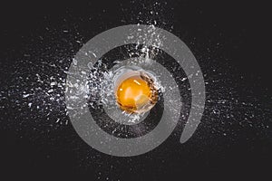 Explosion of glass ball and egg yolk