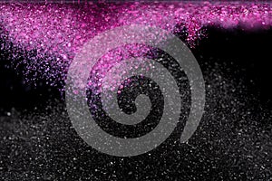 Explosion metallic pink black glitter sparkle. Choky Glitter powder spark blink celebrate, blur foil explode in air, fly throw photo