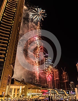 Explosion of multi-colored fireworks at Burj Khalifa Dubai against the night sky on a new year celebrations holidays in Dubai, UAE