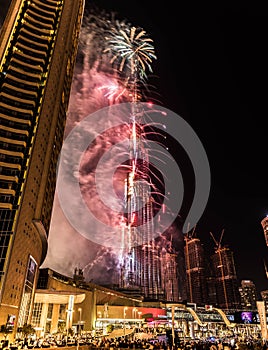 Explosion of multi-colored fireworks at Burj Khalifa Dubai against the night sky on a new year celebrations holidays in Dubai, UAE