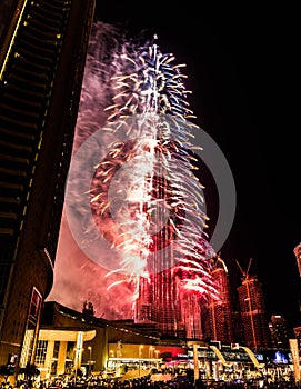 Explosion of multi-colored fireworks at Burj Khalifa Dubai against the night sky on a new year celebrations holidays in Dubai, UAE