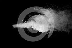 Explosion of white dust on black background.