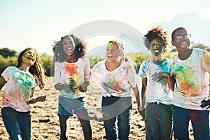 Explosions of laughter and fun. Shot of a group of teenagers having fun with colourful powder at summer camp.