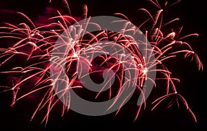 Bright festive fireworks against  black night sky. Flashes and colorful rays of light in dark. photo