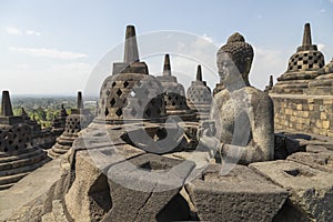 Exposed Buddha, Dharmachakra mudra, on top of the Borobudur temple