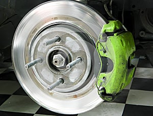 Exposed disk brake with caliper