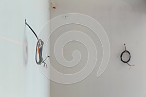 Exposed electrical wires on wall