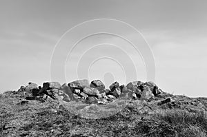 Exposed stones at the top of a cairn known as the millers grave on midgley moor in calderdale west yorkshire